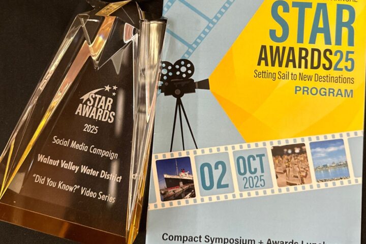 A glass STAR AWARDS 2025 trophy and an event program for the 28th Annual STAR Awards at the Queen Mary, Long Beach, CA, on October 2, 2025, are displayed on a black surface.